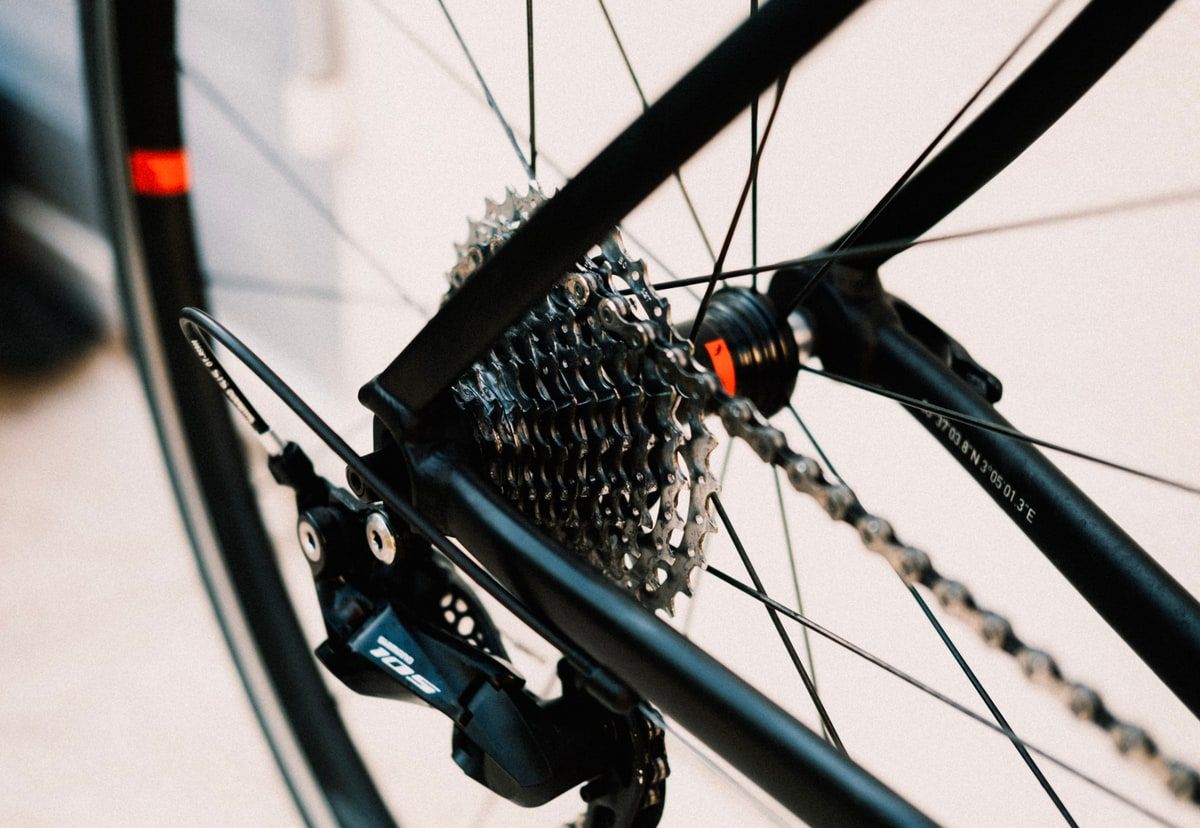 A close-up natural-colour photograph of a bicycle cassette, chain and rear derailleur, representing precise Laravel performance tuning