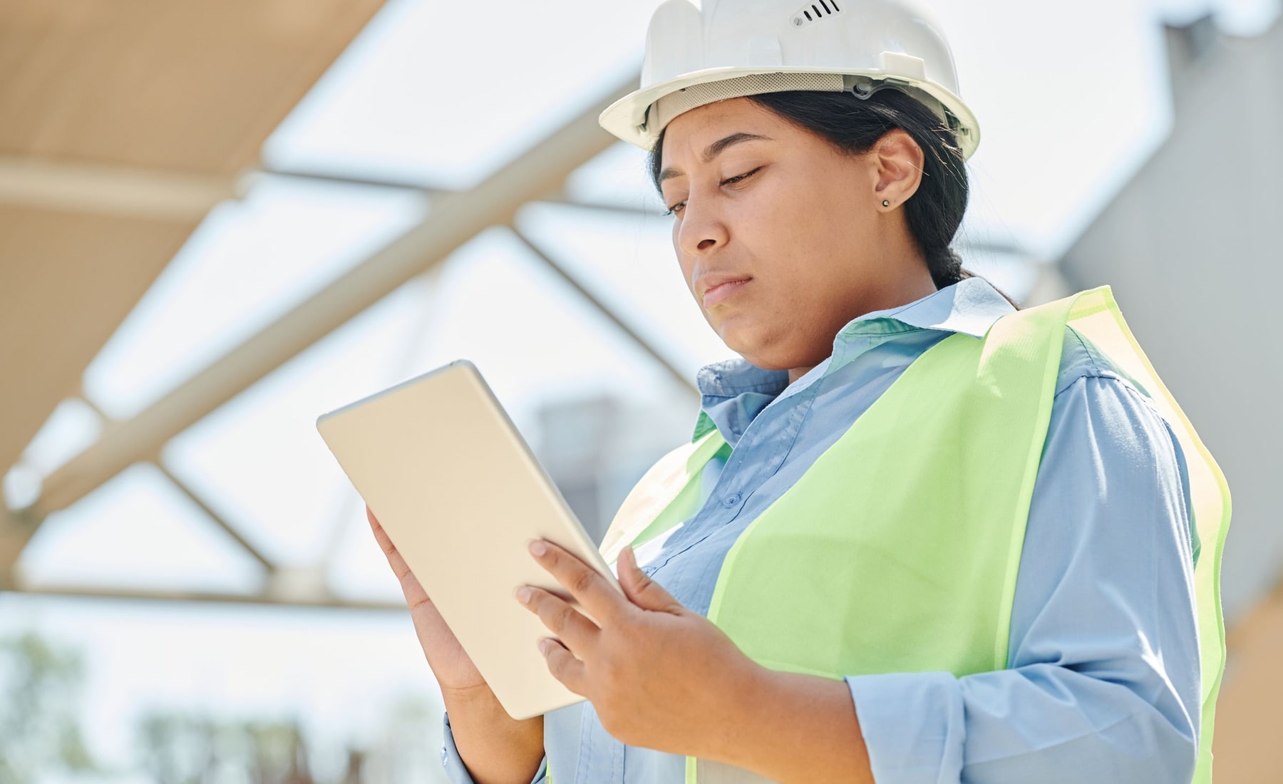 A field engineer using a tablet while working at a construction site