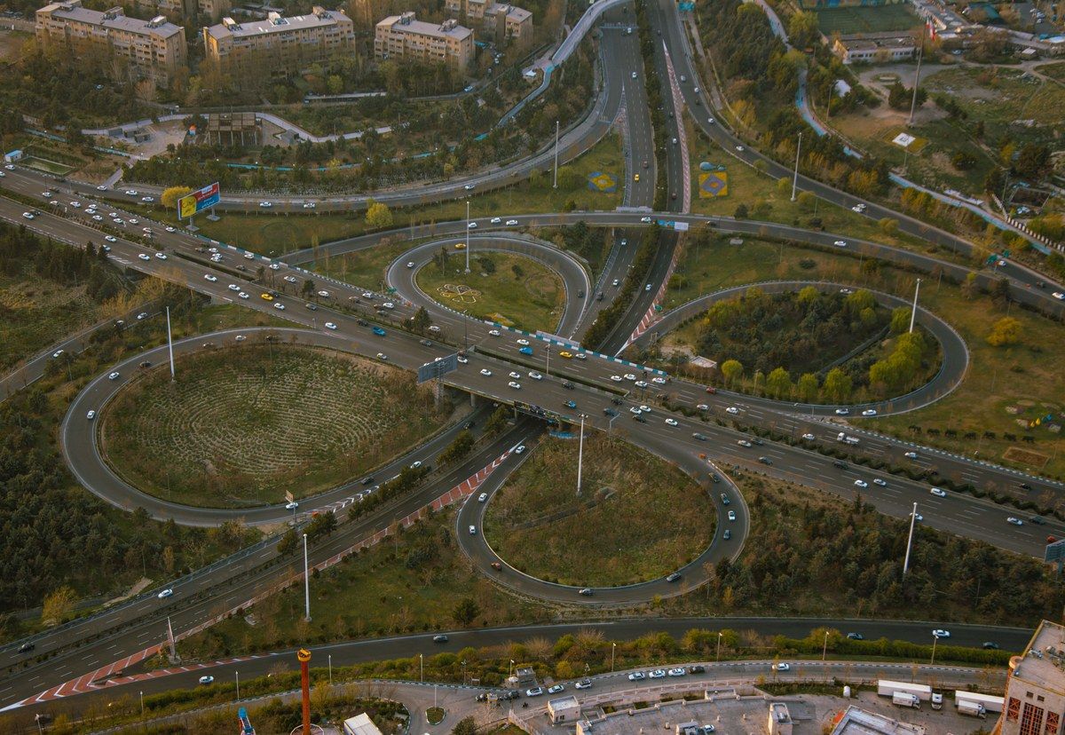 Aerial view of a complex road interchange carrying traffic through several connected routes.