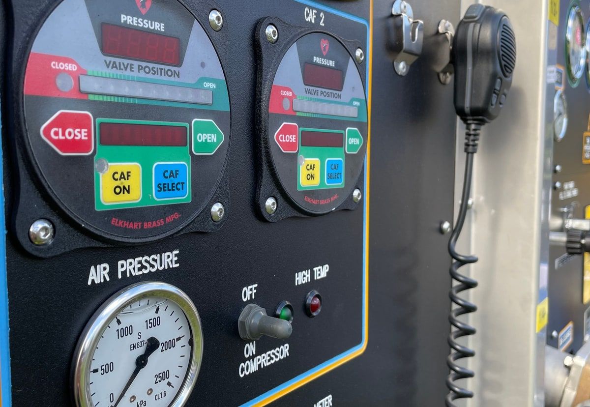 Industrial control panel with pressure gauges, switches and indicator lights used as a visual metaphor for website and application monitoring