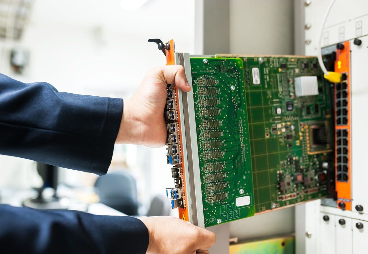 Technician installing network hardware in a data centre server rack