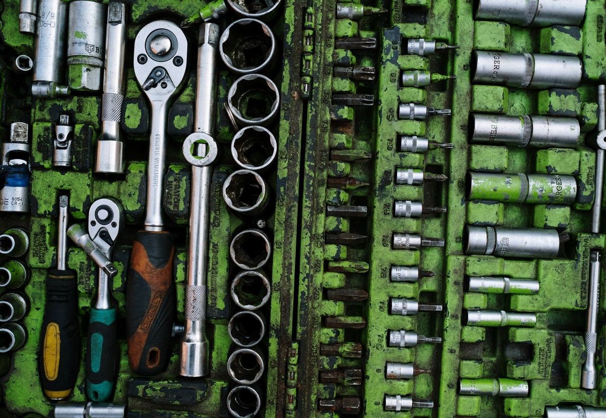An organised green tool case containing ratchets, sockets and screwdrivers, representing the frontend tools brought together by Vite+