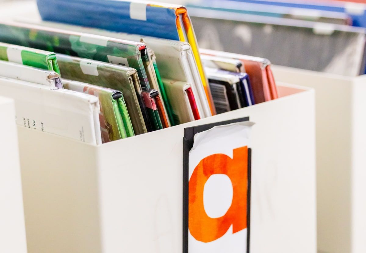 Colour coded paper files arranged in an open office drawer