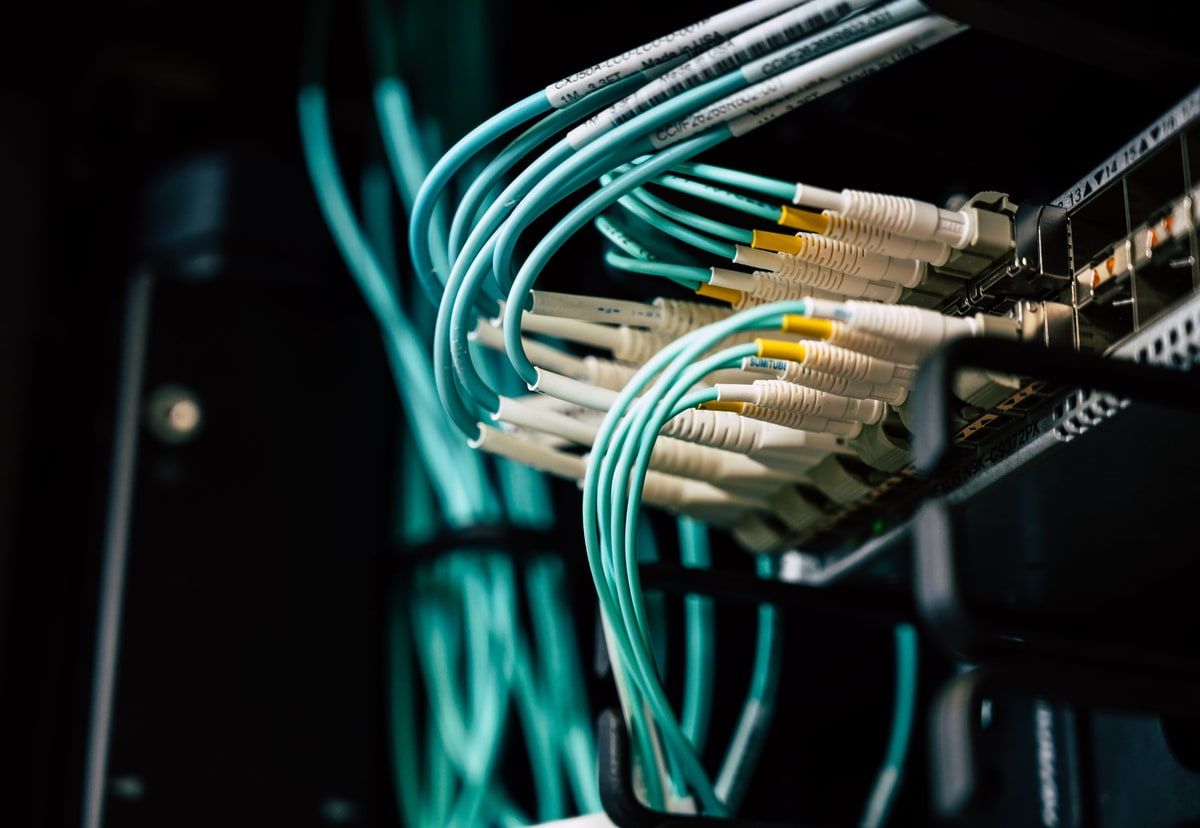 A close natural-colour view of labelled network cables connected to server hardware, representing an organised Proxmox home lab