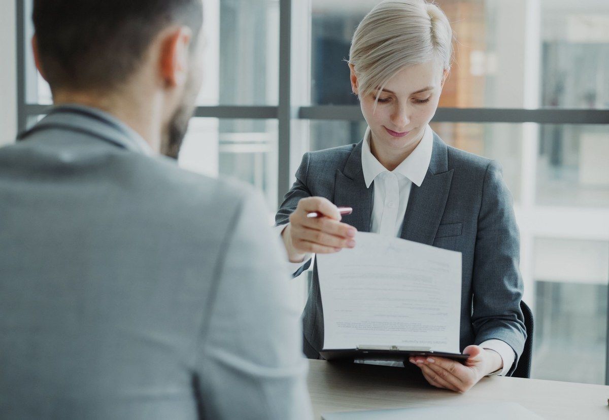 Two business professionals reviewing a contract together before making a supplier decision
