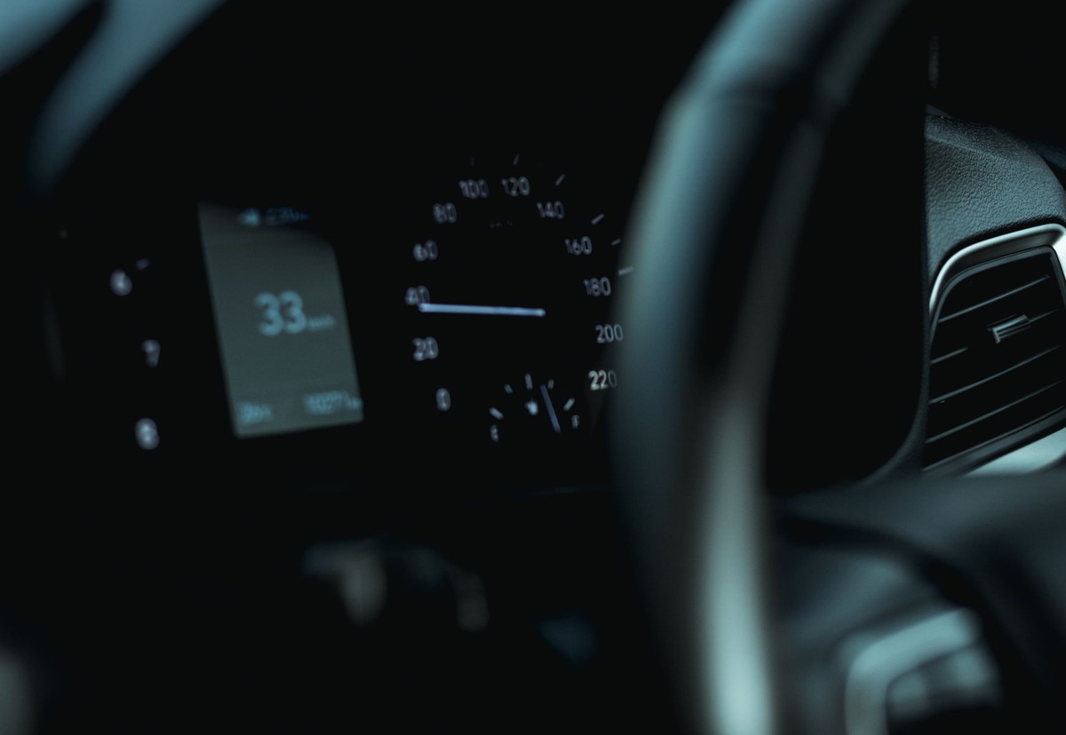 Close-up of a vehicle instrument panel and steering wheel used as a metaphor for a SaaS dashboard