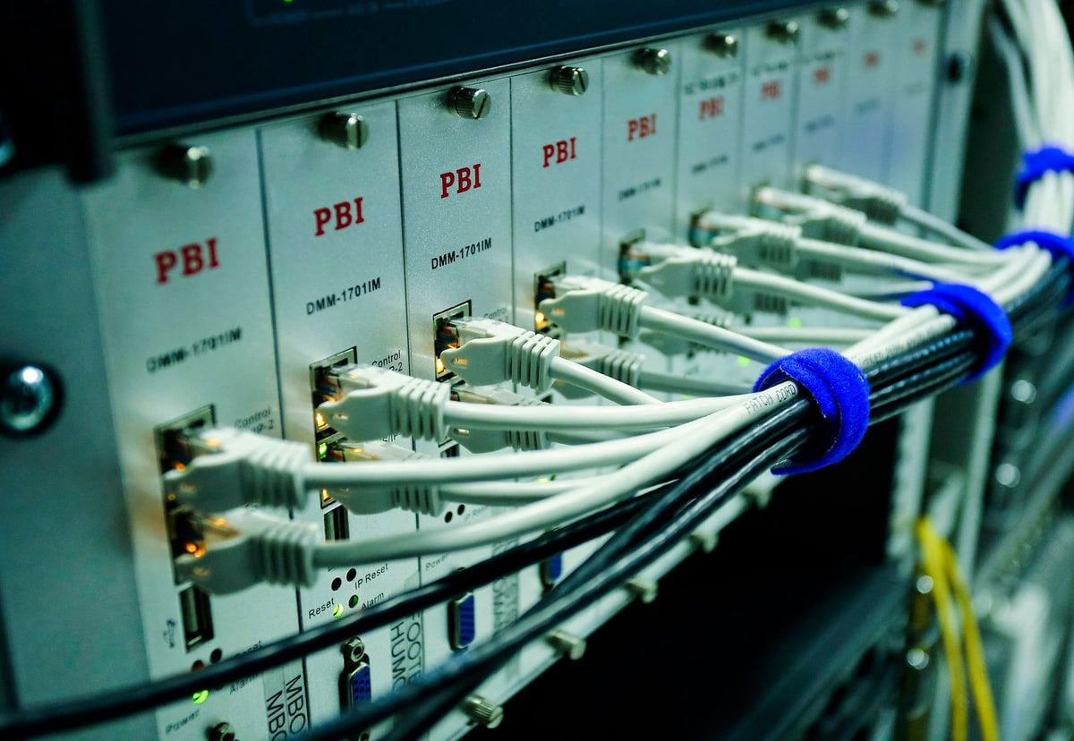 Ethernet cables connected to a network switch, representing AI requests being routed through shared infrastructure.