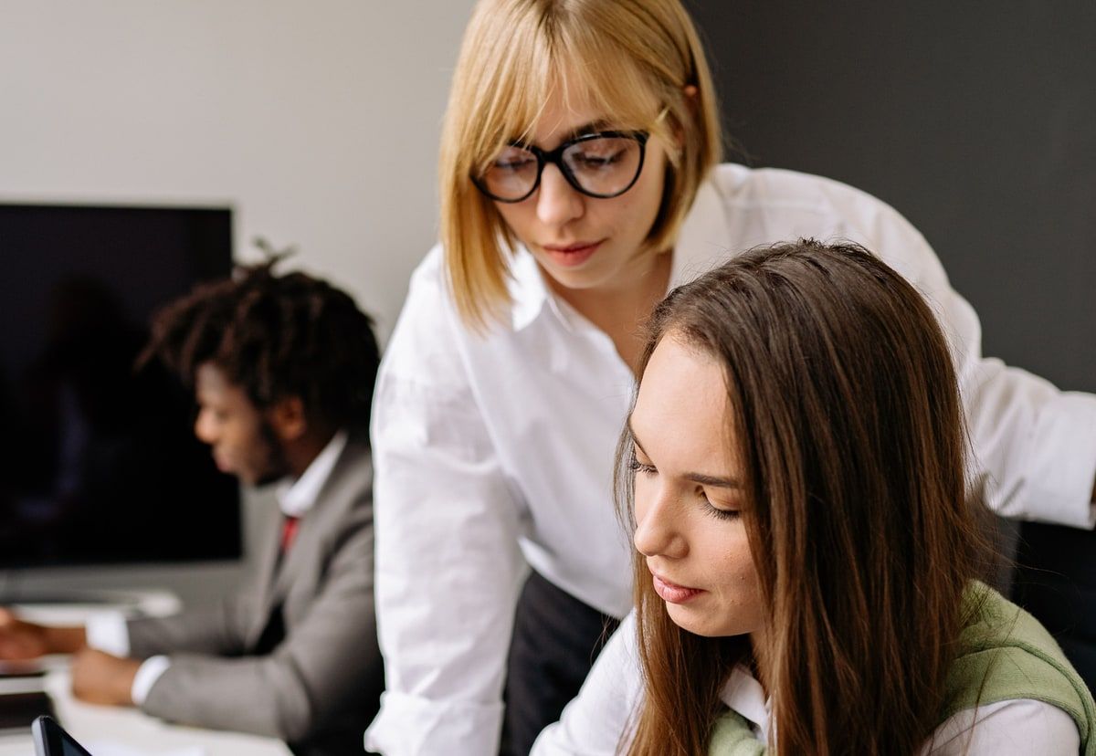 Two colleagues reviewing a digital experience together on a tablet in an office