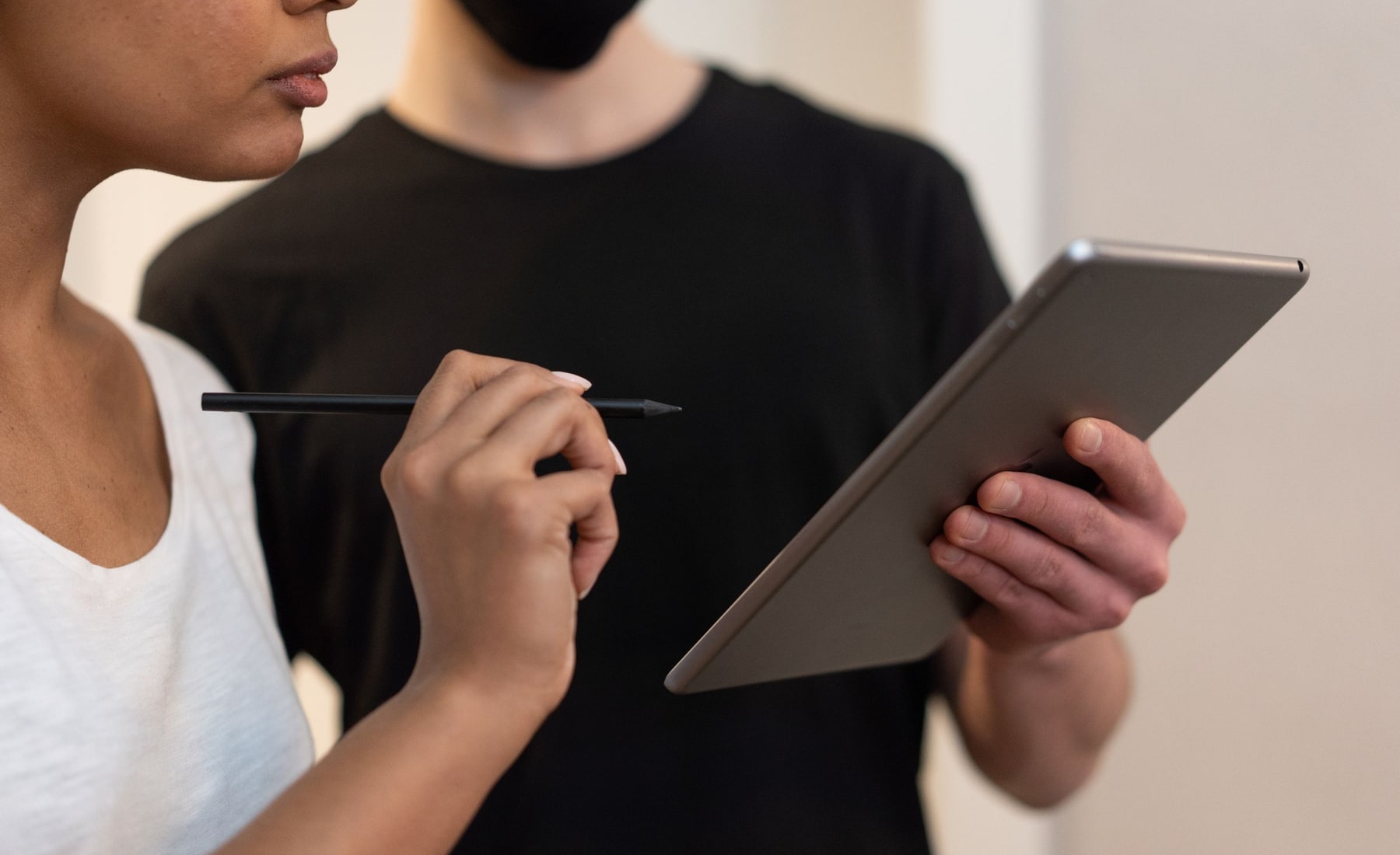 Two people reviewing a tablet together during a product research session