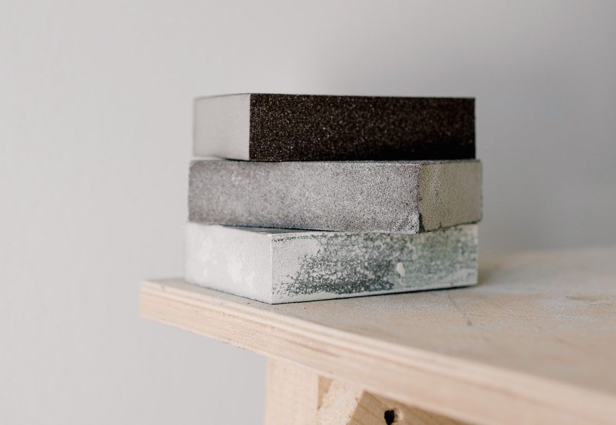 Three differently textured blocks stacked on a wooden workbench