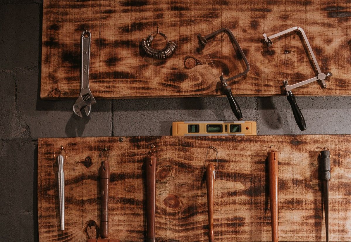 Natural-colour workshop wall with hand tools arranged in expected places, representing the shared structure and reusable facilities of a software framework