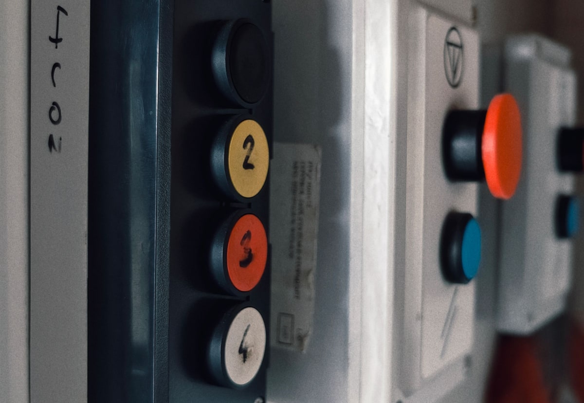 Close-up of a well-used industrial control panel with numbered buttons